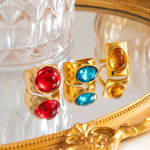 Macro detail of French vintage gold rings with red, blue, and amber gemstones