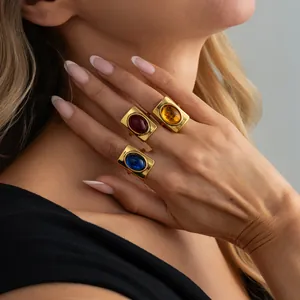 Detailed shot of vintage French style gold rings with red, blue and amber gemstones