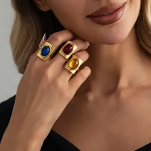 Detailed view of French vintage square rings with colorful gemstones and gold finish
