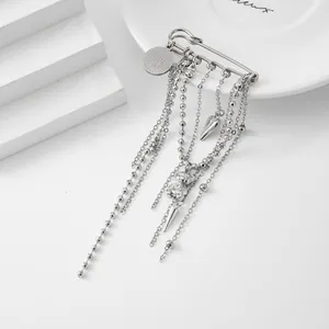 Detailed view of silver heart and bear tassel brooch pin with LOVE engraved charm