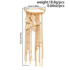 Close-up detail of a fashion gold flower brooch with long tassel chains and pearls