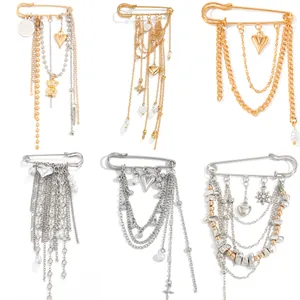 Collection of safety pin brooches with chain tassels and heart bear charms