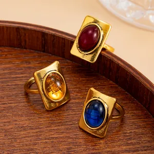 Detailed view of French retro square rings with colorful oval gemstones in vintage gold