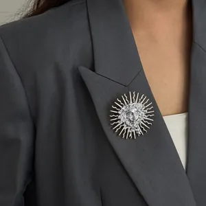 Creative silver sun goddess relief brooch pinned elegantly on a professional grey suit lapel