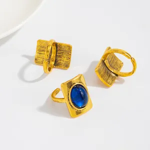 Macro view of three gold vintage rings featuring a blue gemstone and carved texture