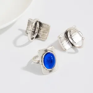Detailed view of vintage silver rings with blue oval gemstone and adjustable bands