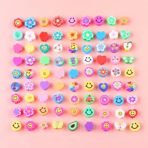 Colorful polymer clay bead assortment with smiley faces and fruit designs