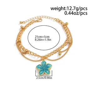 Detail of blue floral charm anklet with gold multi-layer chain and size measurements.