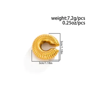 Macro detail of gold ribbed stainless steel C-shaped ear cuff with 3cm dimensions