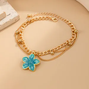 Bohemian gold multi-layer anklet featuring a blue enamel flower charm and gold metal beads