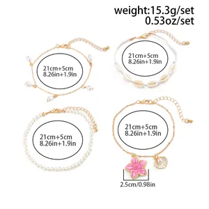Detailed view of bohemian anklet set with shells, pearls, and pink flower charm details