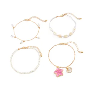 Set of four Bohemian beach anklets featuring shells pearls and pink oil-drop flower charms