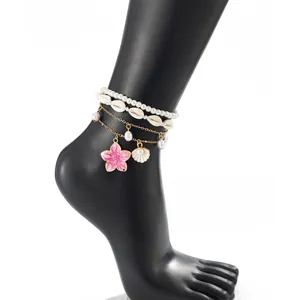 Detailed shot of multi-layer beach anklet with pink enamel flower and white shells