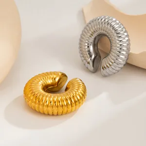 Detailed view of ribbed C-shaped stainless steel ear cuff earrings in gold and silver finish