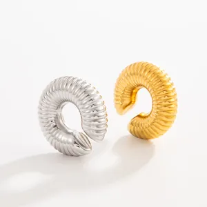 Detail shot of ribbed stainless steel C-shaped ear clips in gold and silver finishes.