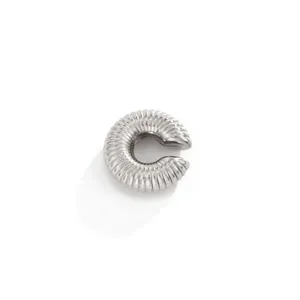 Macro detail of a textured silver stainless steel C-shaped ear cuff with threaded ridges.