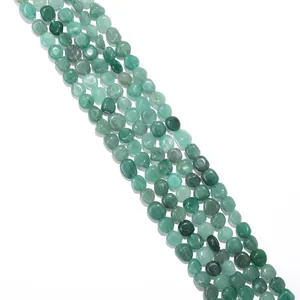 Close-up of natural green stone beads with smooth polished finish for DIY jewelry