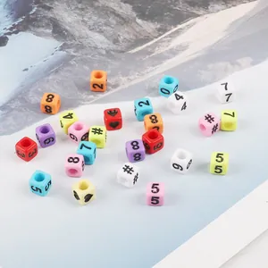 Assorted colorful square acrylic beads with numbers and heart symbols for DIY jewelry.