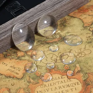 Transparent round and oval glass cabochons for DIY jewelry making on vintage map