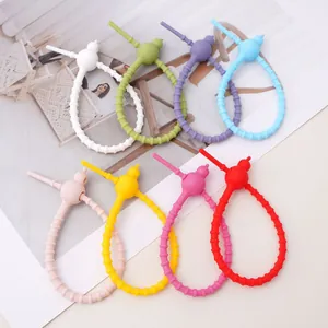 Detailed view showing multi-colored silicone gourd ties for DIY keychains and bag accessories