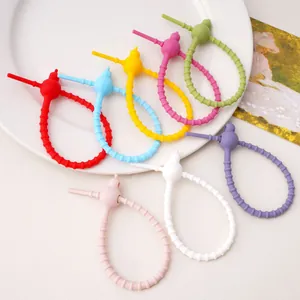 Close-up of colorful multi-functional silicone gourd ties for DIY keychain craft accessories.