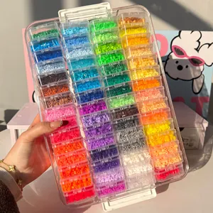 Large clear storage case filled with colorful fuse beads in individual containers.