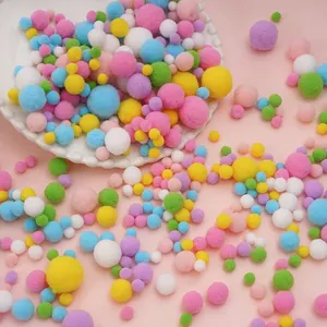 Close-up of vibrant assorted sizes polyester pom poms for DIY kids crafts and decor.