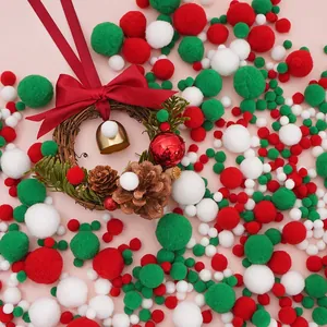 Detailed macro view of red, green and white DIY plush pom-poms with a festive Christmas wreath