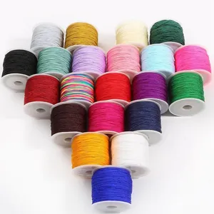 Multiple colors of 0.8mm nylon jade thread spools arranged in a creative heart shape