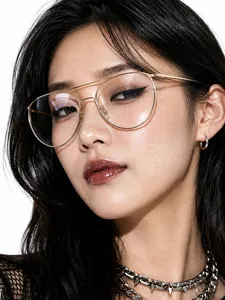Detailed view of retro golden aviator glasses with thin metal frame on an Asian model