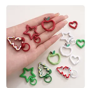 Detailed view of colorful Christmas-themed DIY metal keychain clips in various shapes