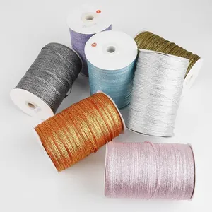 Macro view of multi-colored 4mm metallic glitter ribbons on spools for DIY crafts