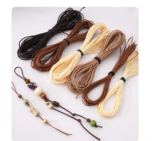 Detailed macro view of various earthy tones of waxed cord for DIY jewelry making