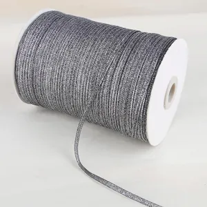 Close-up of 4mm silver metallic ribbon on a white spool for high-end DIY gift packaging.