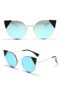 Close-up of cat-eye sunglasses with blue mirrored lenses and gold metal frames