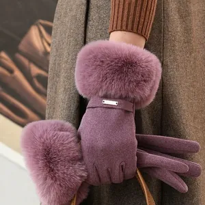 Close-up of purple winter gloves with luxurious faux fur trim and touch screen feature.