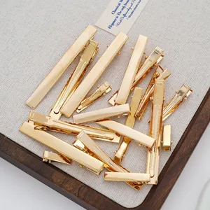 Variety of gold metal duckbill hair clips for DIY accessory making projects