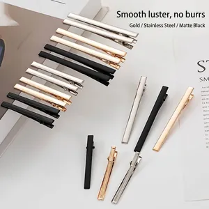 Detailed view of assorted metal alligator hair clips in gold, silver, and matte black