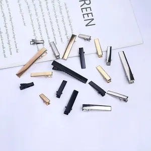 Detailed view of assorted metal duckbill hair clips in silver, gold, and black colors.