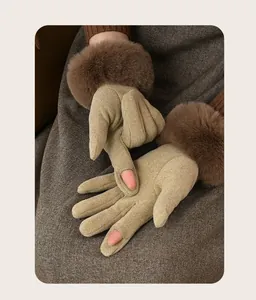 Close-up of winter warm gloves featuring thick faux fur cuffs and finger openings.