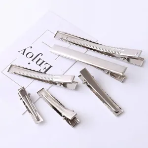 Detailed view of various sized silver metal alligator hair clips for DIY projects