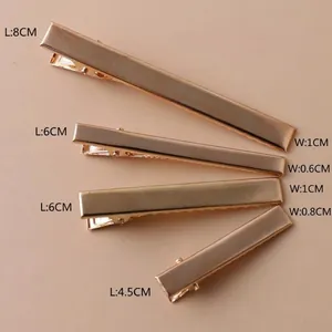 Detail shot of gold metal alligator hair clips with multiple size measurements shown.