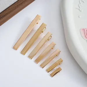 Detail view of gold metal alligator hair clips in seven different lengths for DIY