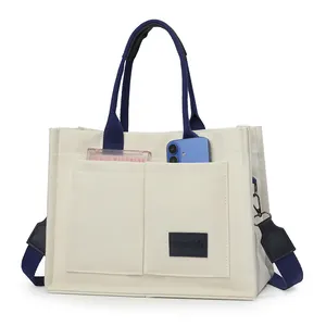 Minimalist large capacity canvas tote bag with multi-pockets and wide blue shoulder strap