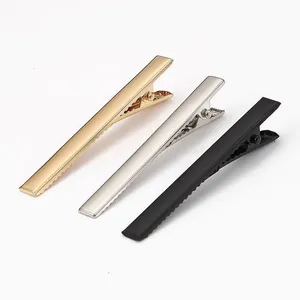 Close-up detail view of metal duckbill hair clips in gold, silver, and black finishes.