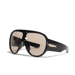 Futuristic oversized Y2K shield sunglasses featuring black frames and tinted tan lenses