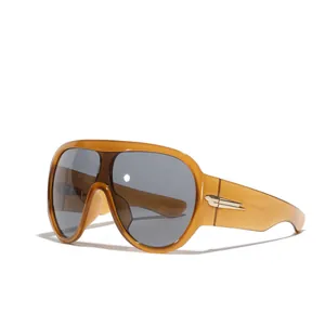 Futuristic Y2K oversized shield sunglasses featuring amber frames and dark grey lenses