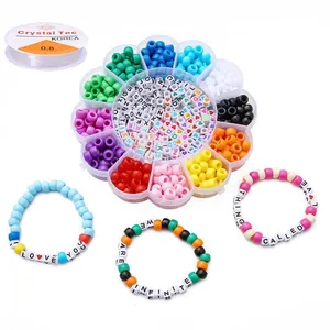 Close-up of DIY jewelry kit with colorful beads, letter beads, and elastic string.