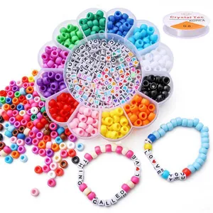 Close-up of DIY bead kit with flower box, letter beads, and finished bracelets.
