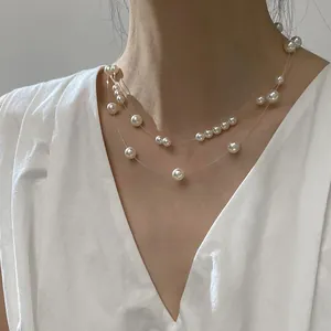 Elegant double-layer pearl illusion necklace with transparent fish line shown on model's neck